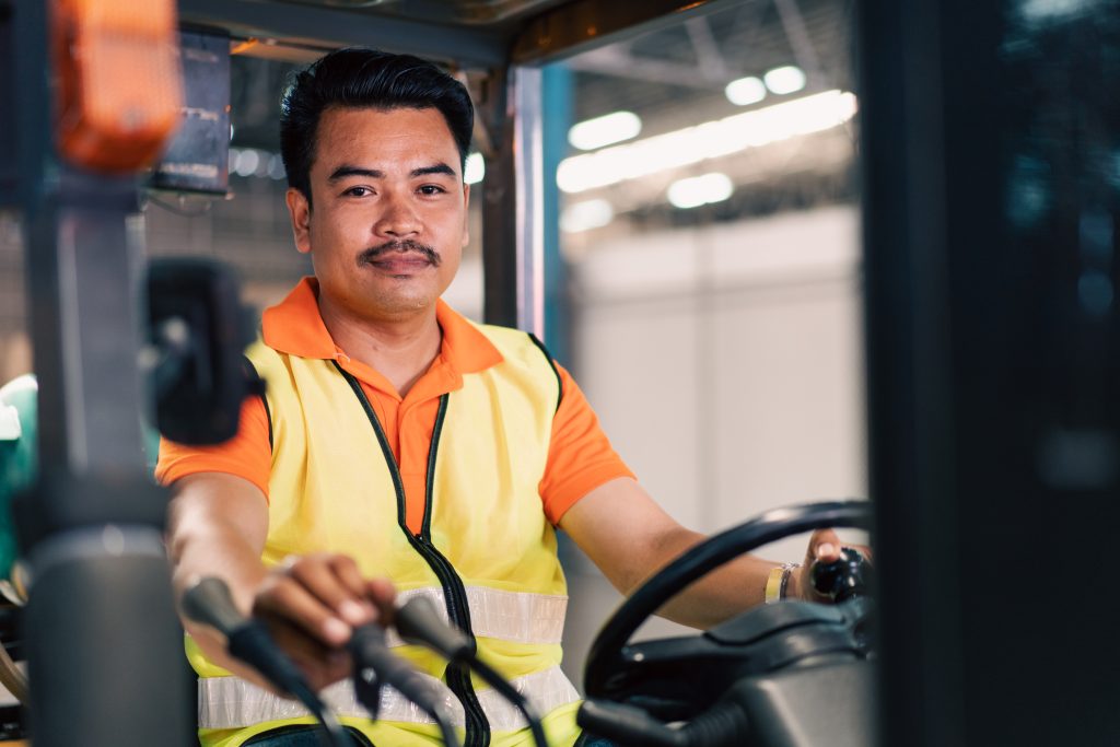 Forklift operator completing hands-on training as part of Seat Time All Forklift Certification inside a warehouse setting.