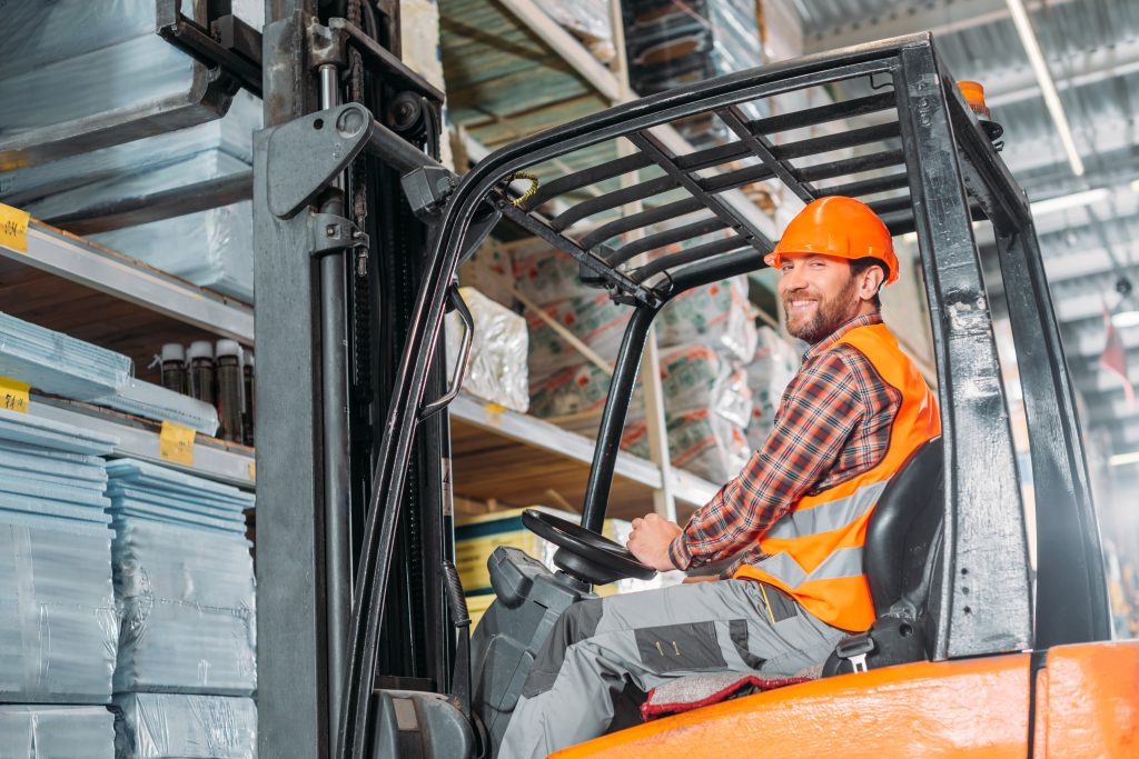 Warehouse forklift operator navigating inventory aisles during Seat Time All Forklift Certification training.